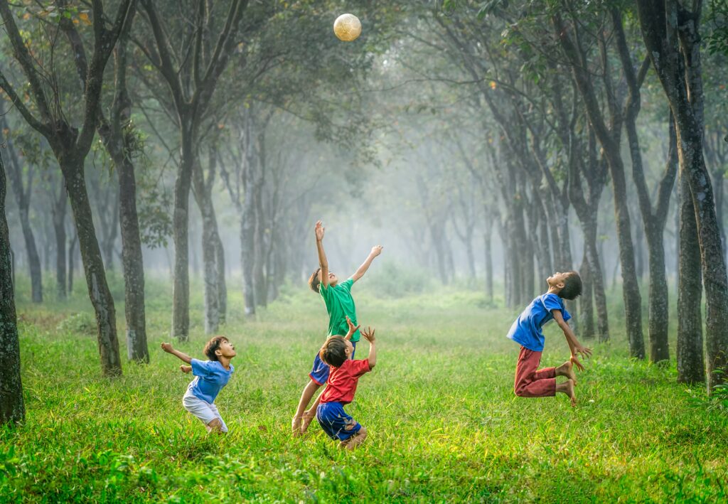 Children of preschool age enjoying playing outdoors 